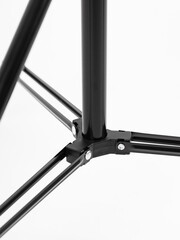 Black Chinese tripod, close-up details. White background.