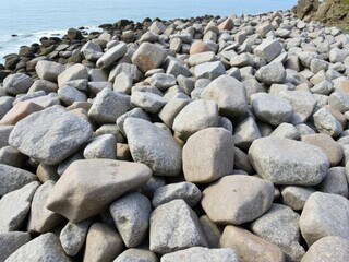 Weathered granite boulders scattered along the North Coast of Anglesey Wales, outdoor scenery, anglesey wales, coastal erosion