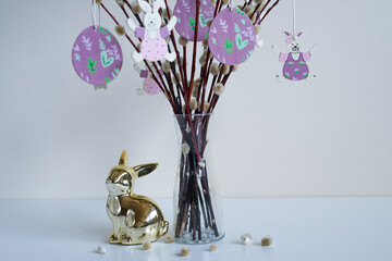 Easter still life with golden bunny and pussy willow bouquet