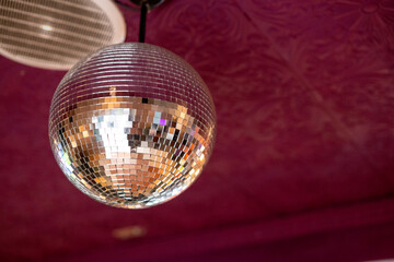 Glowing disco ball seen against ceiling