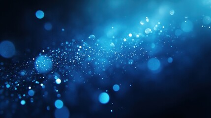 Fototapeta premium A mesmerizing abstract image featuring shimmering blue bokeh lights against a dark background, creating a dreamy atmosphere.
