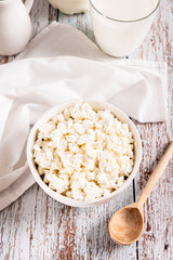 Farm homemade cottage cheese in a bowl on the table vertical view