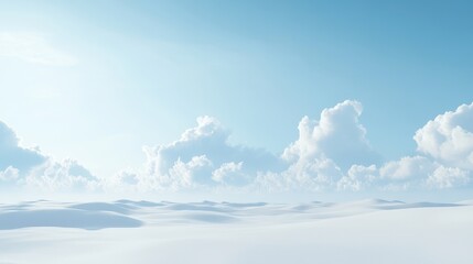 Serene winter landscape featuring soft white snow and fluffy clouds under a bright blue sky.