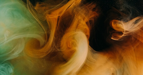 Color mist wave. Ink water splash. Orange green explosion vapor floating flow on dark black dust particles texture abstract art background.