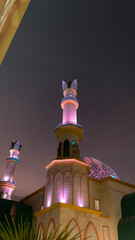 Modern Mosque with Unique Minaret Design at Night