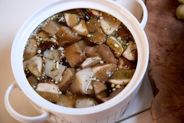 top view of a ceramic pot of cooked mushrooms