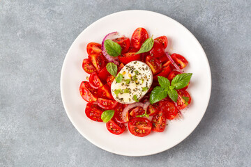 Italian caprese salad with sliced tomatoes, mozzarella, basil, olive oil