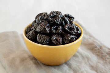 Raw Dried Plum Prunes in a Bowl, side view.