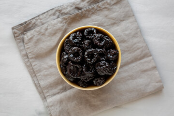 Raw Dried Plum Prunes in a Bowl, top view.