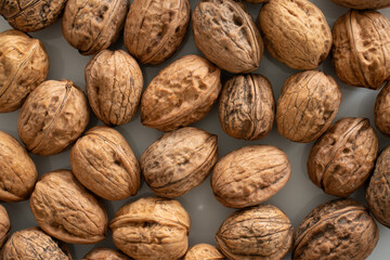 Closeup (macro) of walnuts on a white plate.