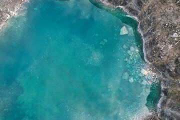 Aerial view of a turquoise water pool in a stone quarry between the municipalities of Sariego and Siero, Asturias, Spain