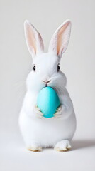 Obraz premium Minimalistic Easter Bunny Portrait – A Cute White Rabbit Holding a Vibrant Turquoise or Coral Egg Against a Clean White Background. Pastel Tones, Sharp Details, and a Modern, Playful Aesthetic 9:16