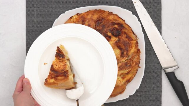 Chef presents a freshly baked phyllo dough pie with a golden crust, showcasing a decadent cream cheese filling. High quality 4k footage