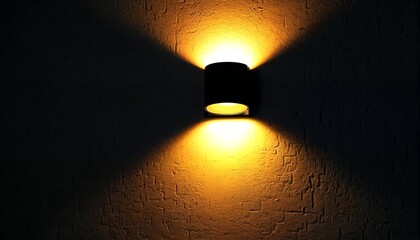 A dimly lit room with two wall sconces emitting soft yellow light through their transparent glass shades.