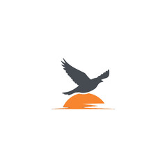 Obraz premium Bird Flying Over Sunset Vector Logo Design