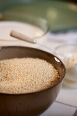 a ceramic bowl with breadcrumbs stands on the table