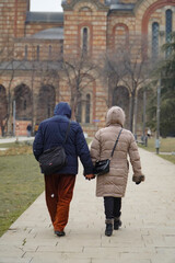 elderly couple showing emotions on the street