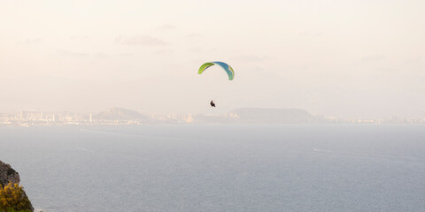 Paragliding by the sea. Mediterranean coast.