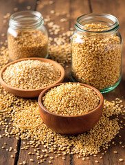 Whole grain assortment with quinoa, brown rice, and rolled oats on rustic wooden background