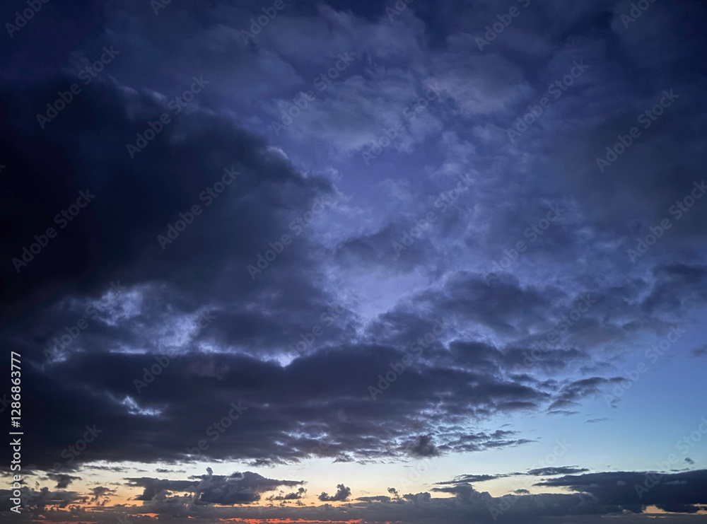 Wall mural cloudy evening sky for use as a background texture