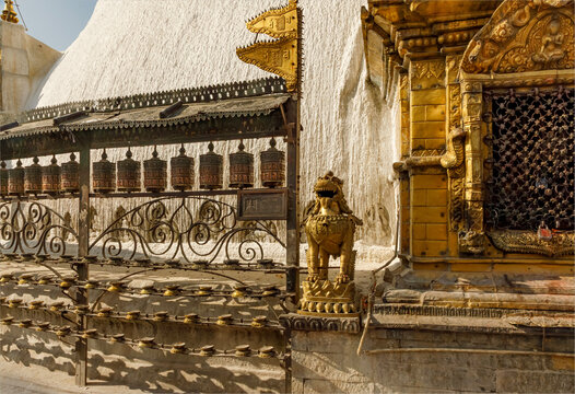 Swayambhunath Stupa  featuring Prayer wheels, butter lamps and a guardian lion statue