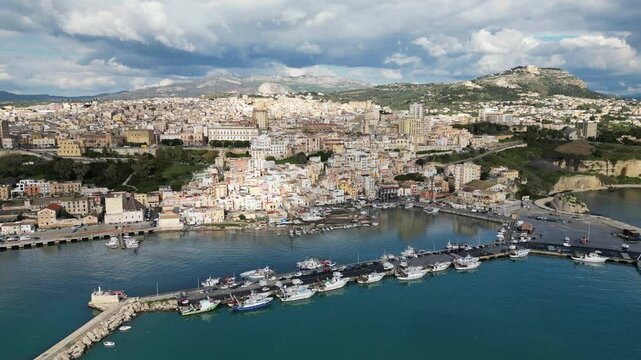 Flying towards fishing harbor and city center of Sciacca, a town in Southern Sicily, travel and commerce in Italy
