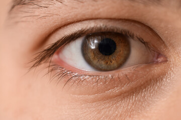Face of young man with green-brown eyes, close up