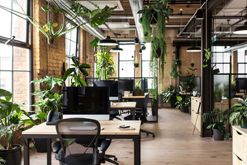 Naklejka premium A modern, stylish office featuring a stunning floor-to-ceiling green wall (living plant wall) as a focal point
