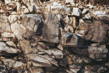 Intricate layers of gray and white rock create a stunning display of natural textures and patterns in a serene outdoor location at dusk. Nature's artistry shines through