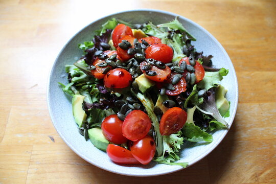 Chopped tomatoes, rocket salad, pumpkins seeds and a sprinkle of balsamic vinegard