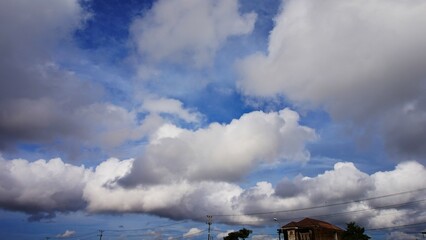 Obraz premium clear blue sky with beautiful white clouds, and tall tower tops. suitable for background