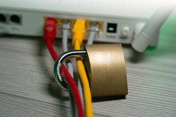 Padlock, router, internet cables (yellow, red). Concept of blocking the internet, internet access to the network to internet content. Internet blocking for children to protect young people