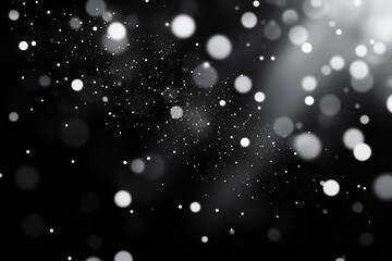 Fototapeta premium Holiday White Snow Bokeh effects on a black background, for a screen or overlay filter, with a festive and magical feel 