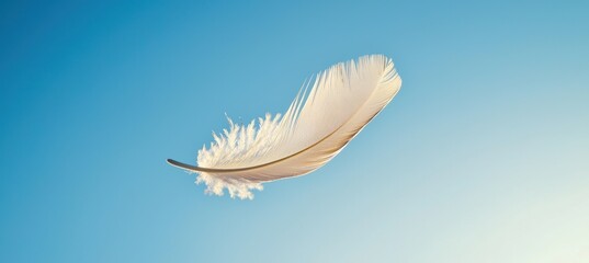 Naklejka premium Feather Drifting Gracefully Against Clear Blue Sky - Serenity and Transience Concept for Posters