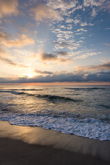 Sunrise over the Ocean with Waves on the Beach