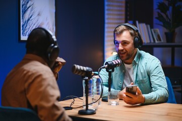 Podcast presenter having live discussion with man, streaming it for audience on internet...