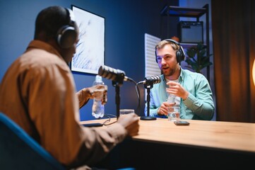 Podcast presenter having live discussion with man, streaming it for audience on internet...