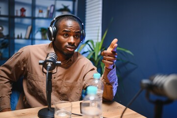 Man smiling while recording podcast in studio