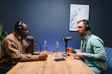 Podcast presenter having live discussion with man, streaming it for audience on internet...