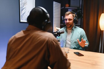 Podcast presenter having live discussion with man, streaming it for audience on internet...