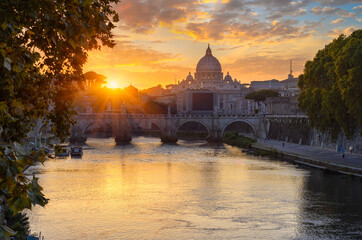 Sunset view of Basilica Saint Peter, bridge Sant Angelo and river Tiber in Rome. Italy....
