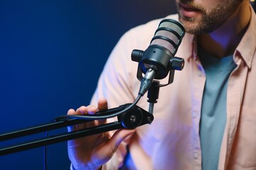 Focus on the microphone and headphones. Podcast studio or recording studio