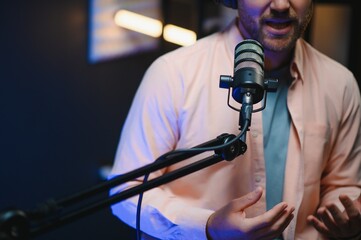 Focus on the microphone and headphones. Podcast studio or recording studio