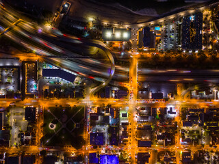Ventura California Drone Aerial view at Sunset with city Lights appearing near the ocean over 101 traffic freeway
