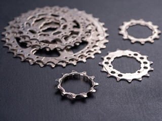 Bicycle sprockets on a dark background.