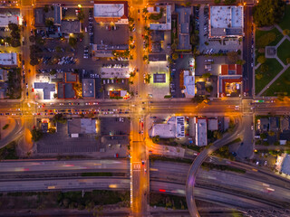 Ventura California Drone Aerial view at Sunset with city Lights appearing near the ocean over 101 traffic freeway
