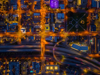 Ventura California Drone Aerial view at Sunset with city Lights appearing near the ocean over 101 traffic freeway