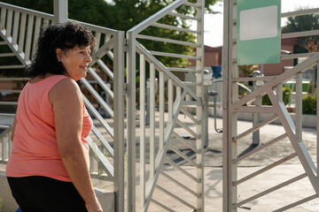 Senior woman entering public outdoor gym for exercise