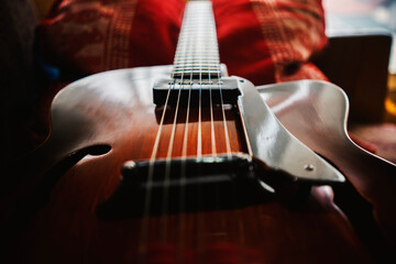 Fototapeta premium Archtop jazz acoustic guitar on the sofa