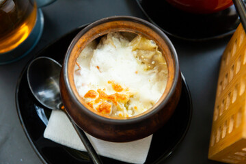 Delicious dumplings in a pot, baked with cream. Close-up image